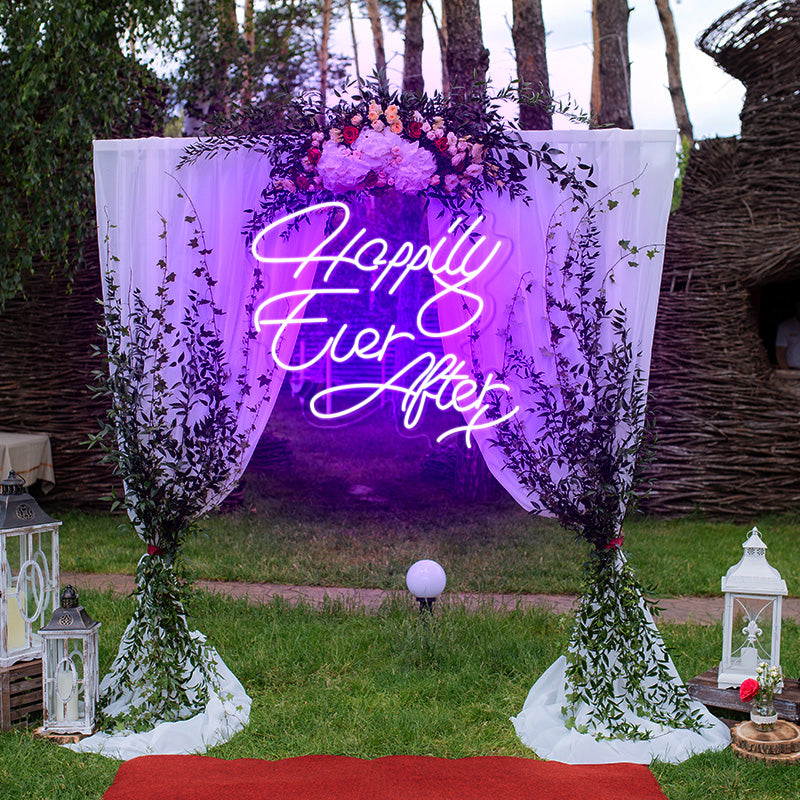 Happily Ever After X neon light in the color purple. The neon light is hanging on a decorate arch at a wedding ceremony. Neon sign produced by Neon Partys.