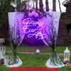 Happily Ever After X neon light in the color purple. The neon light is hanging on a decorate arch at a wedding ceremony. Neon sign produced by Neon Partys.