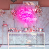 Happily Ever After X neon light in the color deep pink. Installed on wall above food table at bridal event. Neon sign produced by Neon Partys.