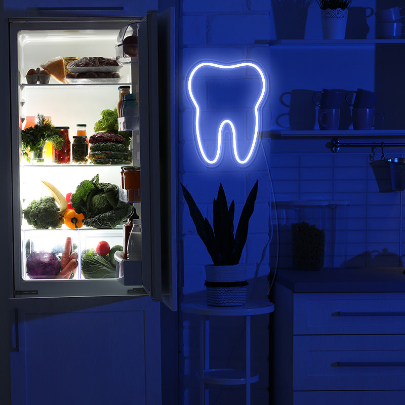 Tooth neon sign on wall. Turned on at night time. Light produced by Neon Partys.