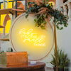 baby it's the small things neon sign in golden yellow installed onto wall at event. Neon sign available online at Neon Partys. 