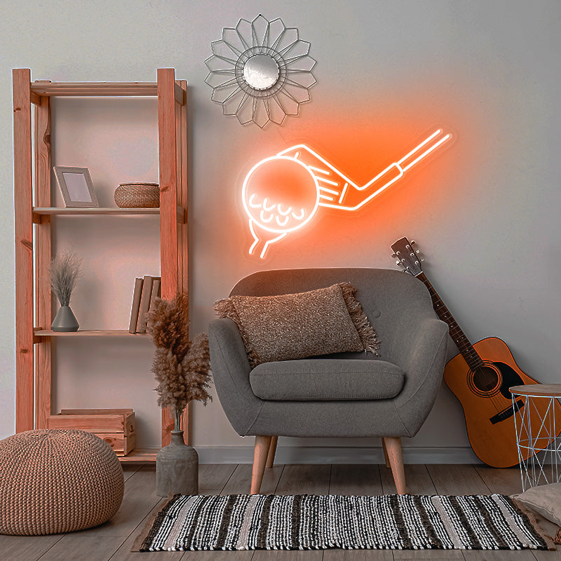 Golf Led Neon Lights in the color orange. Neon light is hanging obove chair in the living space. 