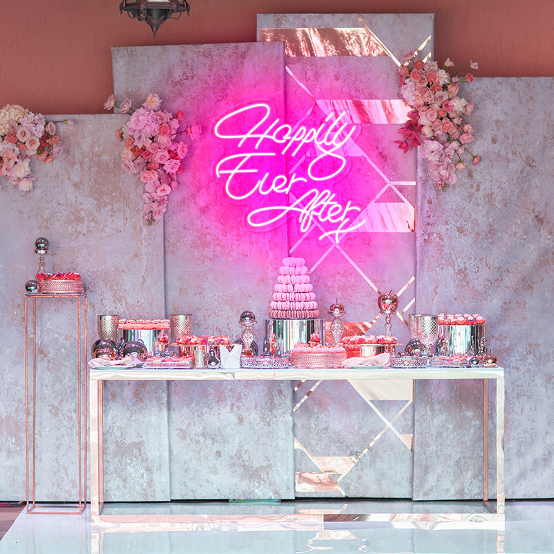 Happily Ever After X neon light in the color deep pink. Installed on wall above food table at bridal event. Neon sign produced by Neon Partys. 