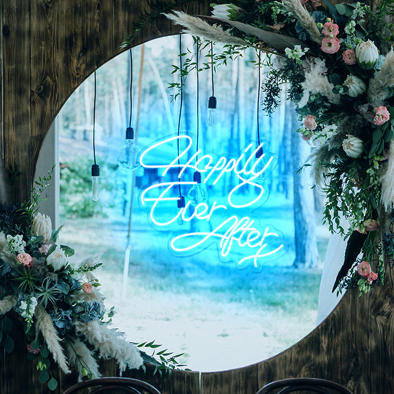 Happily Ever After X neon light in the color Electric Blue. Installed on wall at wedding with a dreamy forest theme. Neon sign produced by Neon Partys. 