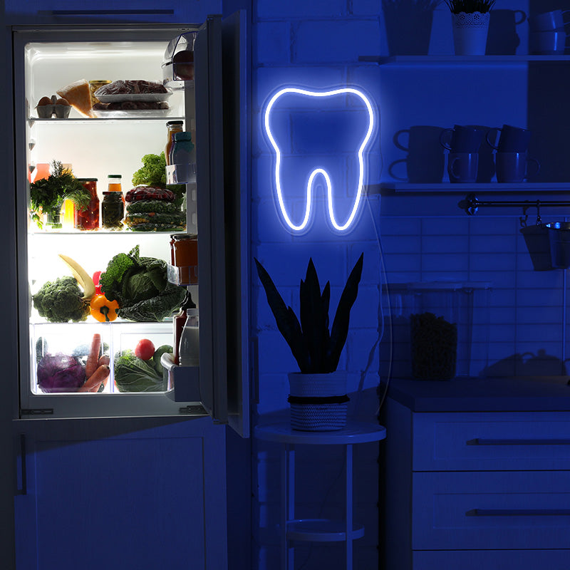 Tooth neon sign on wall. Turned on at night time. Light produced by Neon Partys. 