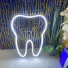 Tooth LED Neon Sign in white on table.  Light produced by Neon Partys. 