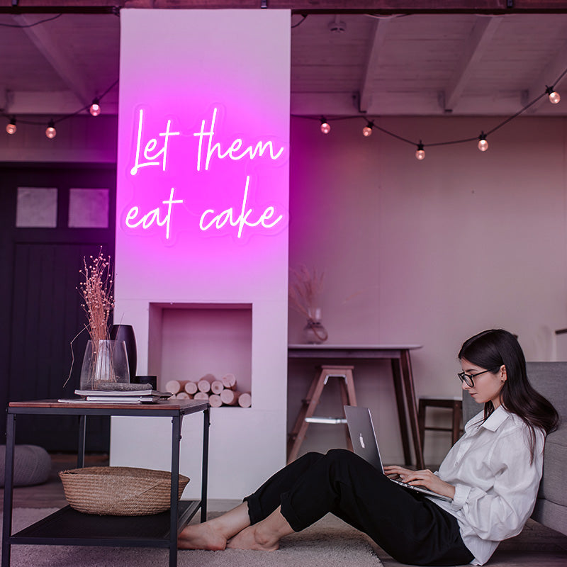 let them eat cake neon sign in the color deep pink. Marie Antoinette cake quote as wall decor at home. Cool and unique wall art. Neon sign produced by Neon Partys. 