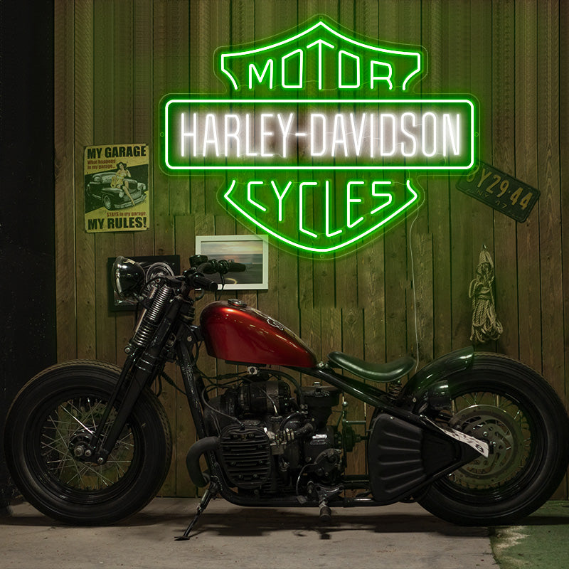 Harley Davidson neon sign of logo in the colors green and white. Installed on timber wall. Hanging above motorcycle. 
